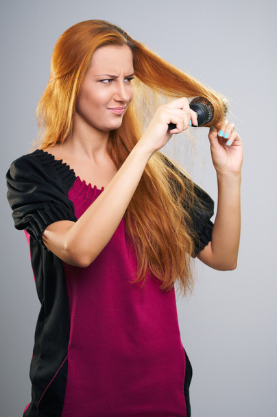 Surprised young woman in a dress. Long red hair caught in the co - Photo, Image