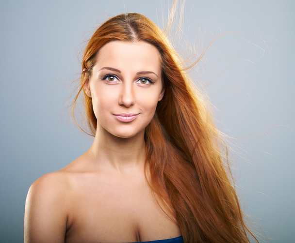 Attractive young woman with long red hair. - Photo, Image