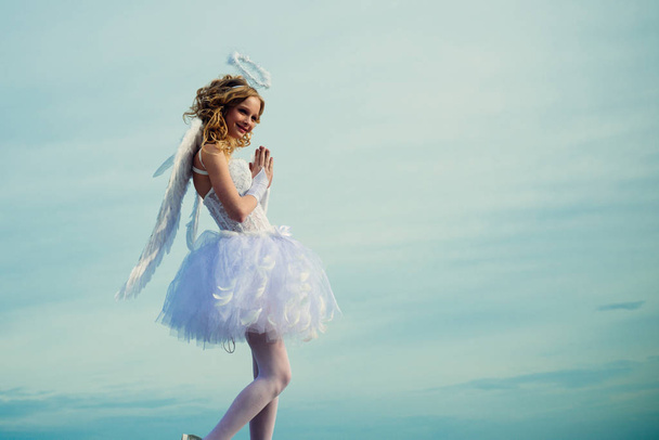 Love concept. Happy teenage angel girl pray. Portrait of little curly blond Angel girl. Angel wings baby pray. Pretty white little girl as the cupid congratulating on St Valentines day. Pray. - Foto, immagini