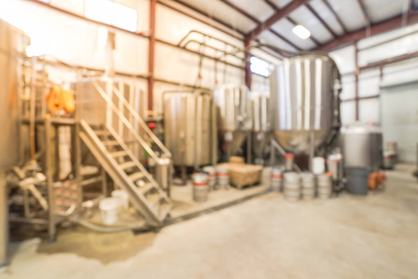 Blurry background stainless steel brewing equipment at American brewery - Photo, Image