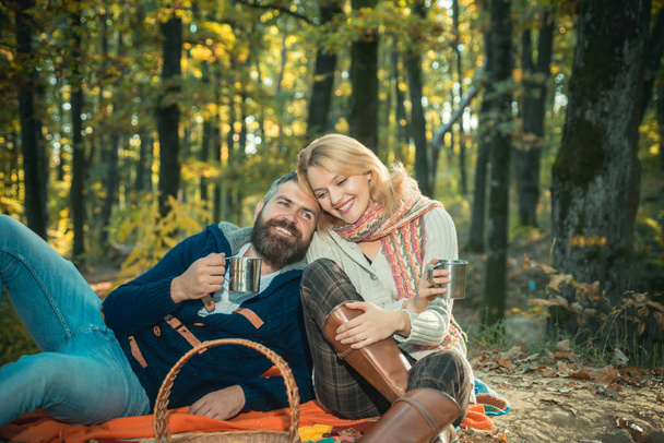 Only two of us an nature around. Tourism concept. Picnic time. Couple relaxing in park together. Romantic picnic forest. Couple in love tourists relaxing on picnic blanket. Romantic date in nature - Valokuva, kuva
