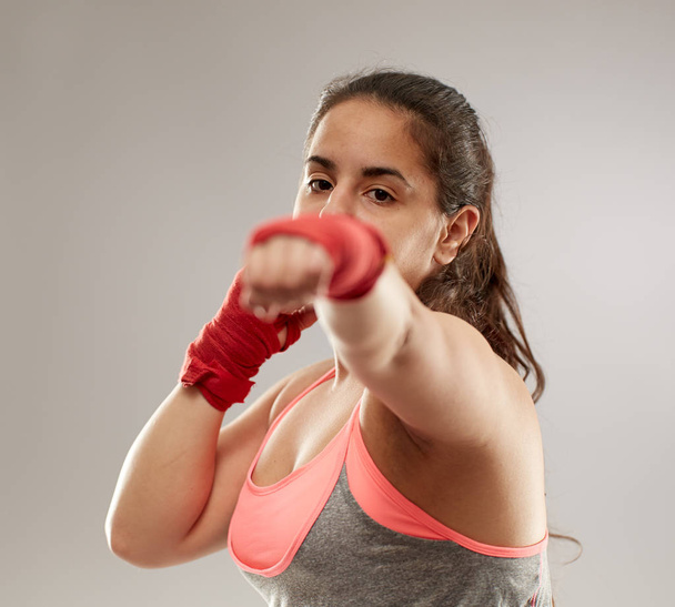 Boxer girl in hand wraps doing shadow boxing - Zdjęcie, obraz