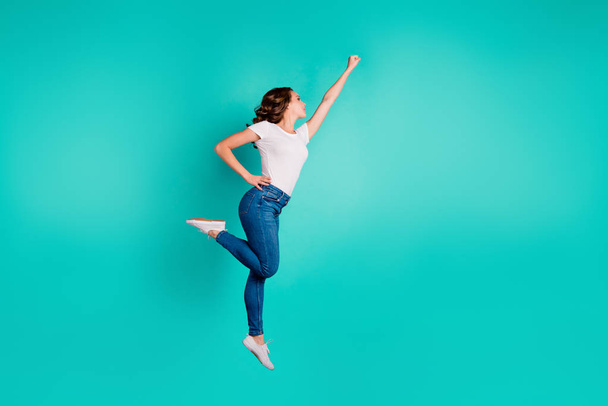 Full length body size profile side view of her she nice-looking attractive cheerful slim fit thin slender wavy-haired lady raising hand up aim isolated on bright vivid shine blue background - Fotoğraf, Görsel