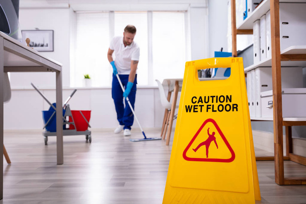 Homem zelador com limpeza esfregona moderno chão de escritório
 - Foto, Imagem
