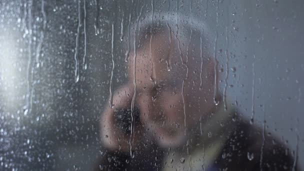 Depressed senior man talking on phone, family communication, old age loneliness - Кадры, видео