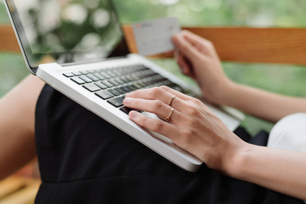 Portrait of a Girl holding credit card and using laptop. Online shopping - Photo, image