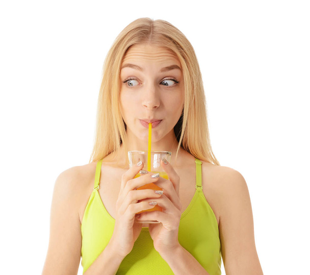 Sporty young woman with glass of juice on white background - Foto, immagini