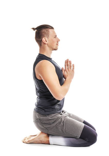 Sporty man practicing yoga on white background - Photo, Image
