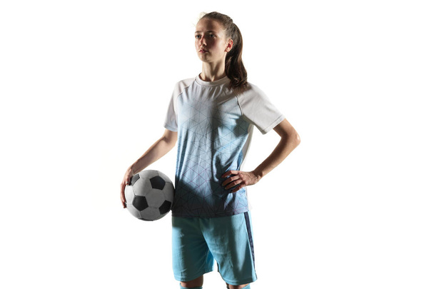 Female soccer player standing with the ball isolated over white background - Foto, imagen