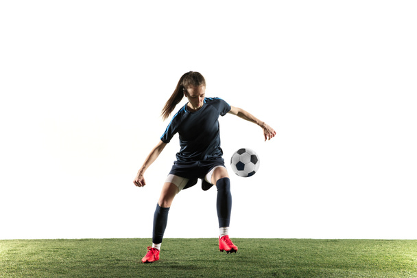 Female soccer player kicking ball isolated over white background - Fotoğraf, Görsel