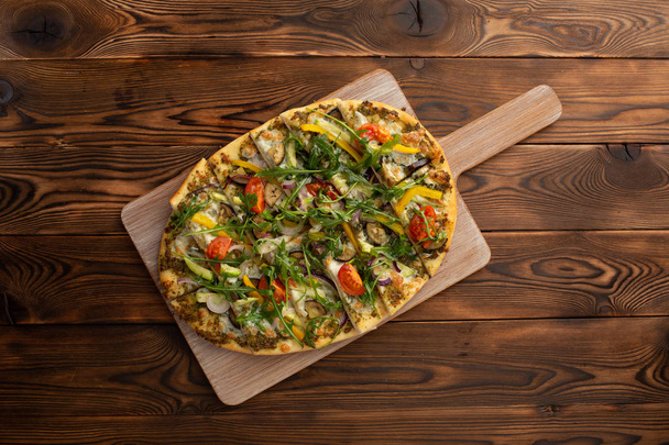 pizza with vegetables and truffle oil on wooden background - Foto, Imagen