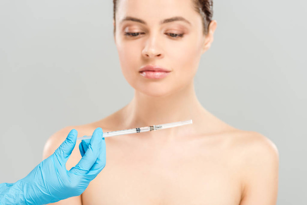 cropped view of cosmetologist holding syringe near naked woman isolated on grey  - Фото, изображение