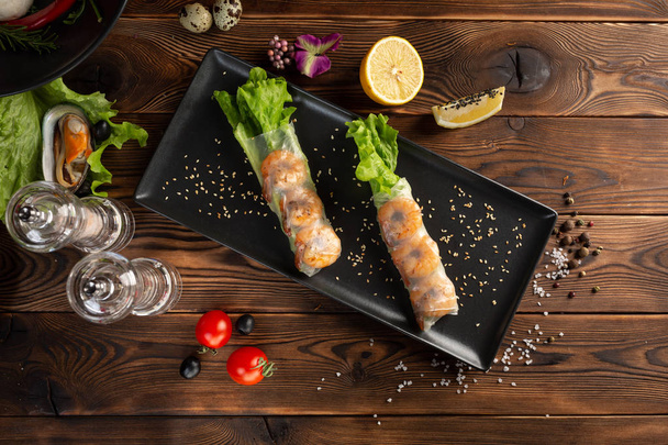 Asian spring rolls with shrimp in black rectangular plate - Photo, Image