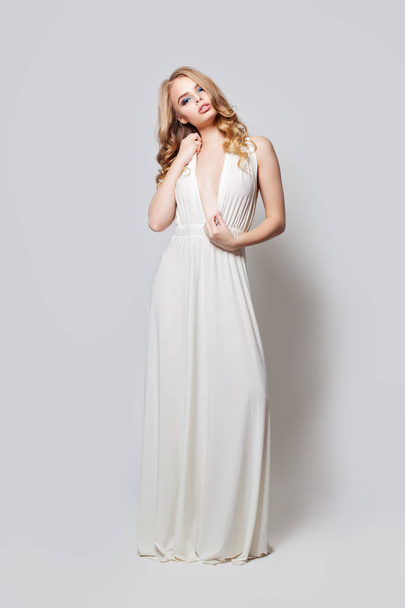 Fashion portrait of beautiful woman in white dress. Blonde model - Zdjęcie, obraz