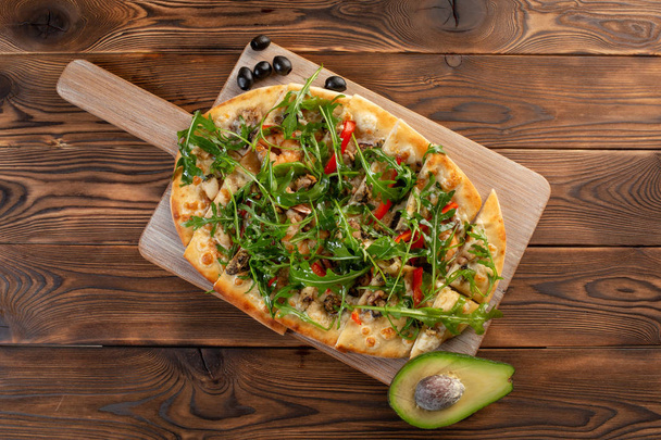 pizza with seafood and arugula on a wooden background - Fotoğraf, Görsel