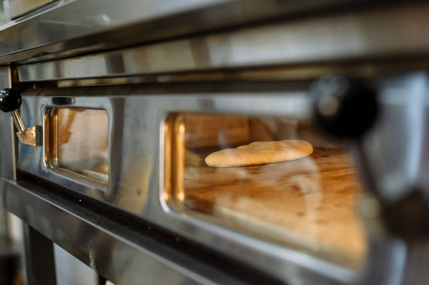 preparation of baking in the electric oven in the kitchen of the restaurant - Photo, Image