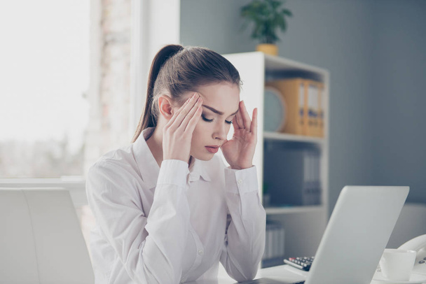 Close up side profile photo beautiful she her business lady suffering terrible head ache hold hands arms forehead temples eyes closed notebook table bright office wear specs formal-wear white shirt - Фото, зображення