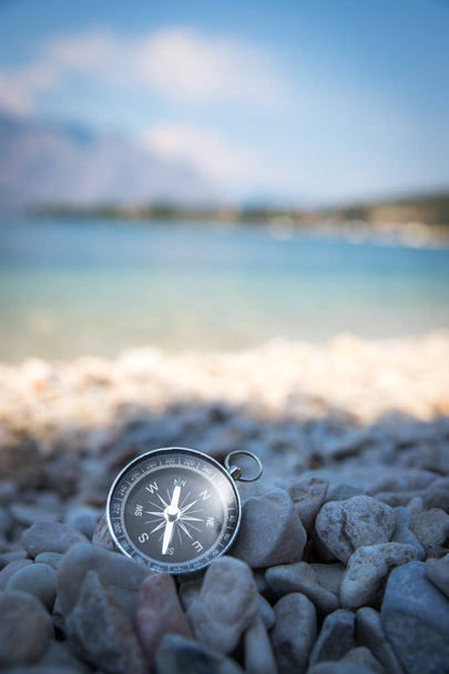 Compass on the beach, small stones, text space - Φωτογραφία, εικόνα