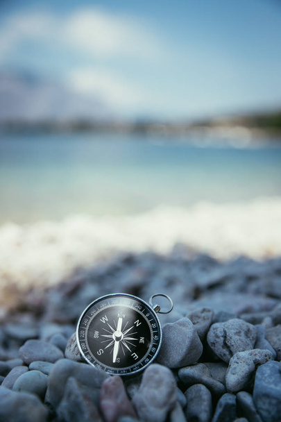 Compass on the beach, small stones, text space - Foto, afbeelding