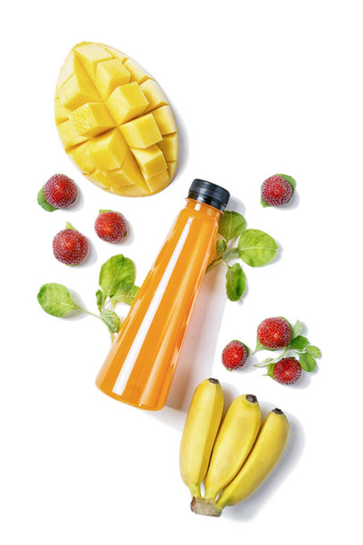 top view flat lay bottle of juice with spinach, mango, banana and strawberry on white background. Healthy lifestyle, vegetarian food concept. Detox  - Valokuva, kuva