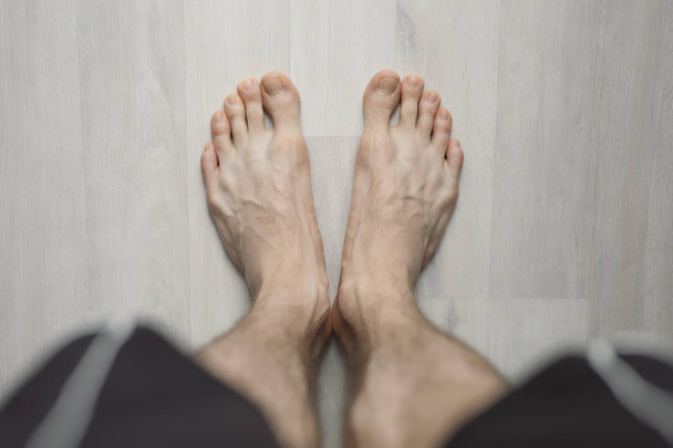 POV, man barefoot on the floor - Zdjęcie, obraz