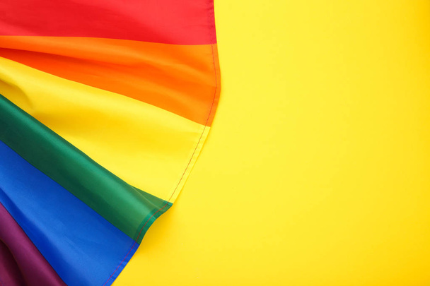 Rainbow flag on yellow background - 写真・画像