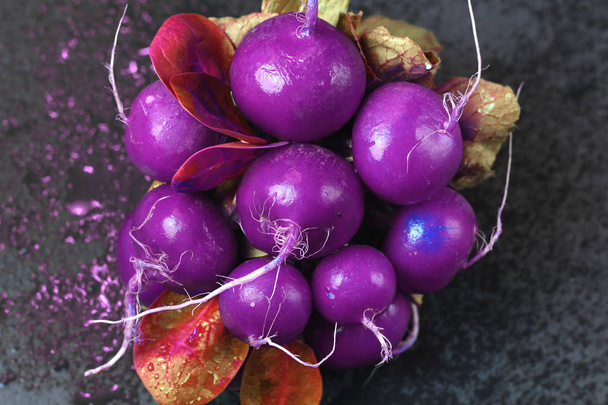 Bright abstract bunch space cosmic alien radioactive infected food  purple  radish with gold leaves  and water drops unnatural colors in the style of pop zine culture. Creative concept - Foto, Imagem