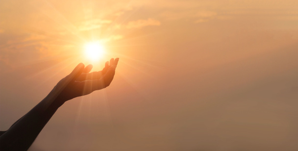 Woman hands praying for blessing from god on sunset background  - Photo, Image