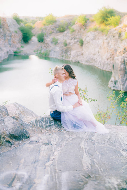 Elegant gentle stylish groom and bride near river or lake. Wedding couple in love  - Photo, Image
