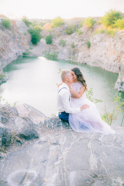 Elegant gentle stylish groom and bride near river or lake. Wedding couple in love  - Foto, Imagen
