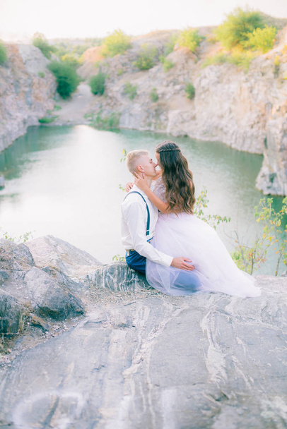 Elegant gentle stylish groom and bride near river or lake. Wedding couple in love  - Photo, image