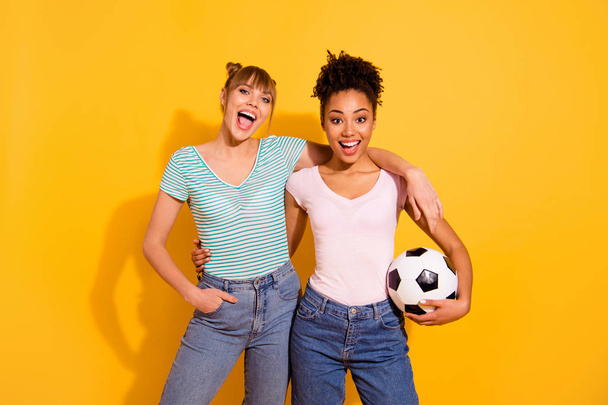 Portrait of positive cheerful content funny funky teen student bun wavy curly top-knot joy hold hand energy train sportswoman wear trendy style stylish jeans t-shirt isolated on yellow background  - Fotografie, Obrázek
