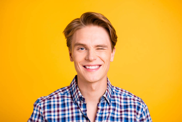 Close up photo amazing youngster he him his man wink one eye perfect styling ready romance date girlfriend white ideal teeth wear casual plaid checkered shirt outfit isolated yellow bright background - Foto, Bild