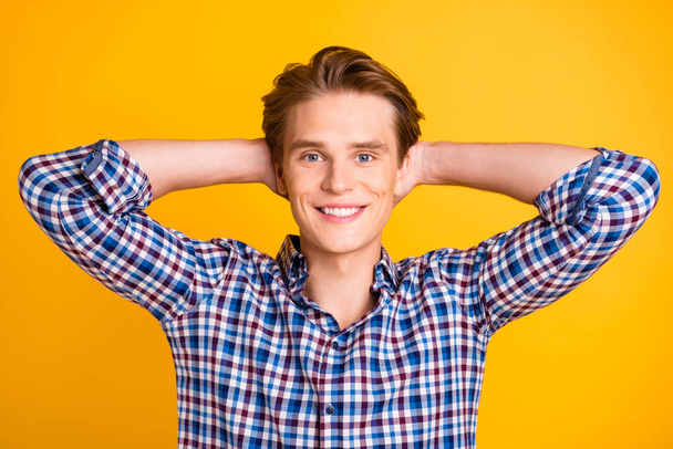 Close-up portrait of his he nice-looking attractive cheerful cheery guy wearing checked shirt enjoying free time isolated over bright vivid shine yellow background - Fotó, kép