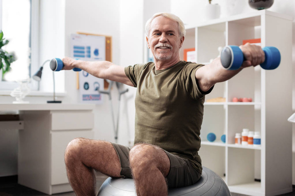 Joyful active man enjoying his physical exercises - Foto, Bild
