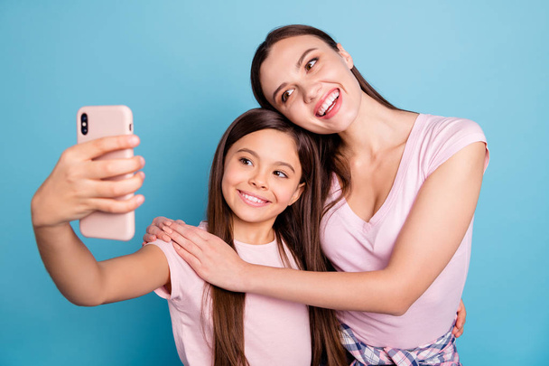 Close-up portrait of two nice cute charming attractive lovely sweet gorgeous cheerful cheery straight-haired girls taking making selfie isolated on bright vivid shine green blue turquoise background - Valokuva, kuva