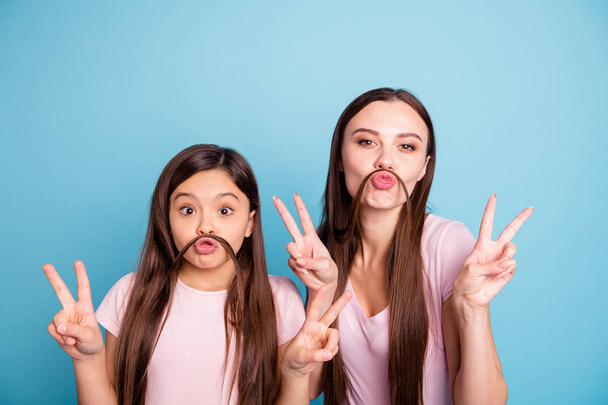Close-up portrait of two nice cute charming attractive cheerful cheery straight-haired girls having fun showing double v-sign isolated on bright vivid shine blue turquoise background - Zdjęcie, obraz