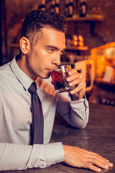 Successful man relaxing while drinking whisky in bar - Φωτογραφία, εικόνα