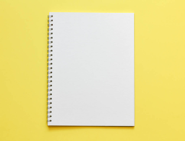 top view of working place with empty notepad on yellow background  - Fotoğraf, Görsel