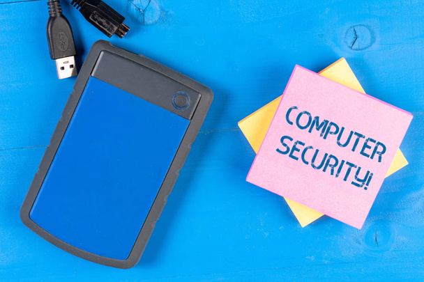 Writing note showing Computer Security. Business photo showcasing protection of computer systems from theft or damage Electronic device USB memory colored sticky note pad wooden background. - Photo, Image