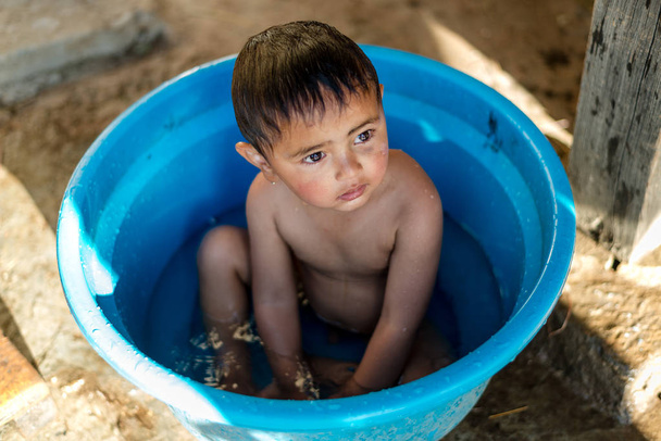Kullu, Χιματσάλ Πρπράντες, Ινδία-01 Μαρτίου 2019: φωτογραφία του παιδιού των Ιμαλαΐων που παίρνει μπάνιο σε μπανιέρα στα Ιμαλάια, κοιλάδα Σεντ - Φωτογραφία, εικόνα