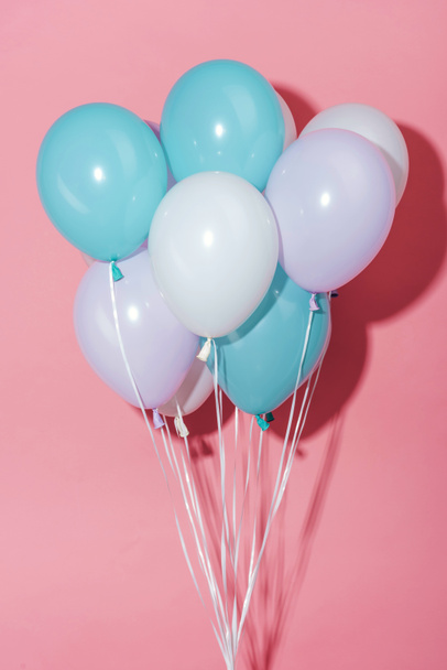 white, blue and purple decorative festive balloons with shadow on pink background - Fotó, kép