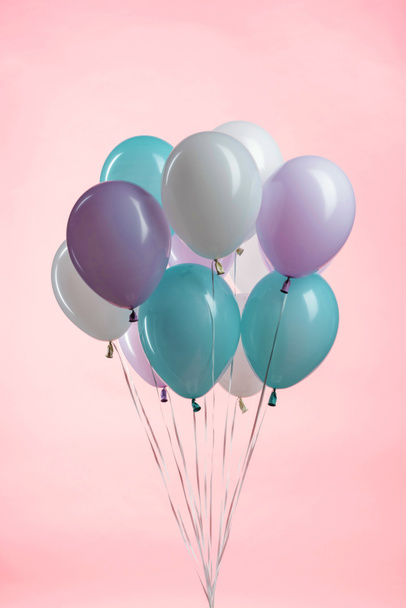 white, blue and purple party festive balloons on pink background - Fotó, kép