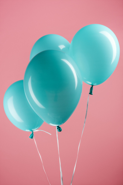 blue colorful decorative festive balloons on pink background - 写真・画像