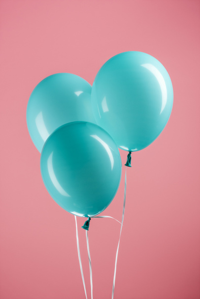blue decorative festive balloons on pink background - Foto, afbeelding