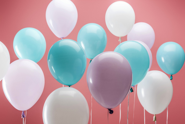bright multicolored decorative balloons on pink background - Foto, imagen