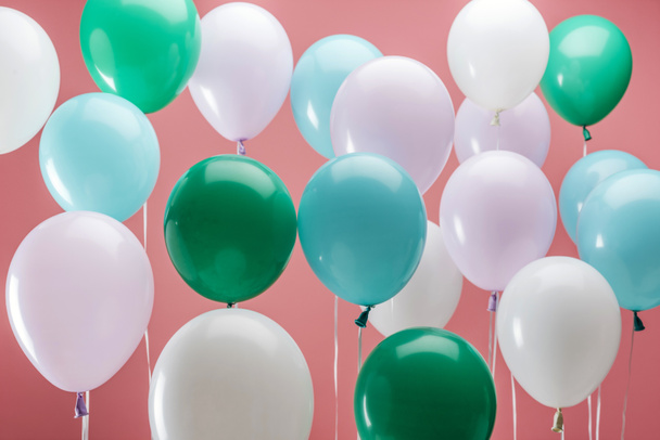 bright green, white and blue party decorative balloons on pink background - Foto, imagen