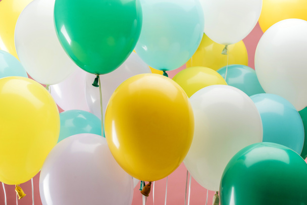 close up view of multicolored decorative balloons on pink background - Φωτογραφία, εικόνα