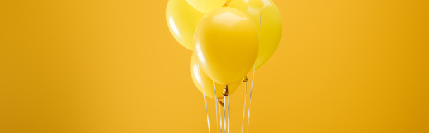 festive minimalistic decorative balloons on yellow background, panoramic shot - Photo, Image