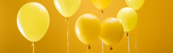party minimalistic balloons on yellow background, panoramic shot - Photo, Image